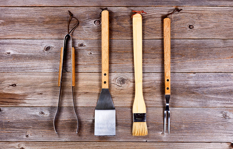 Utilize appropriate utensils to maintain a safe grilling environment.